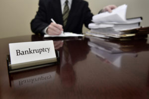 Bankruptcy attorney at desk going through paperwork