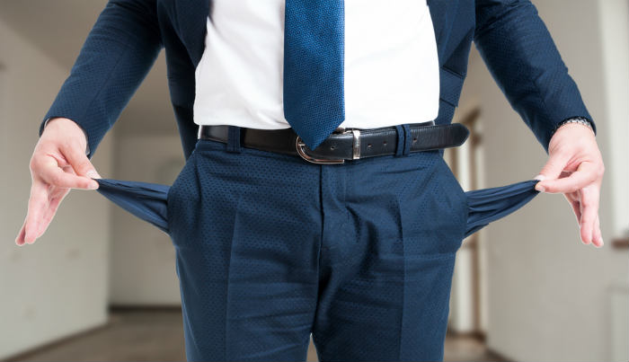 man emptying out his pockets to symbolize bankruptcy