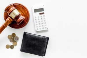 gavel, wallet, calculator and coins.