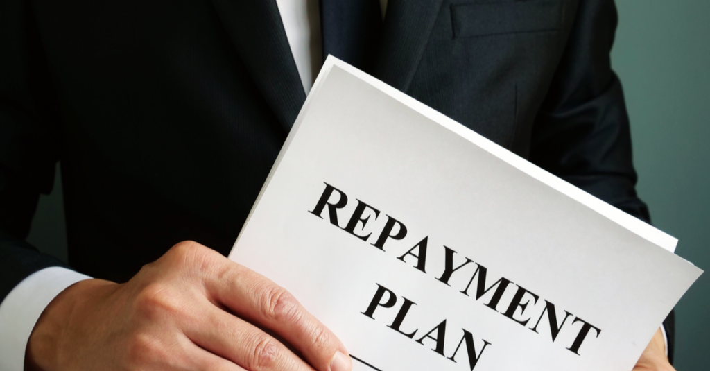a man holding bankruptcy repayment plan documents