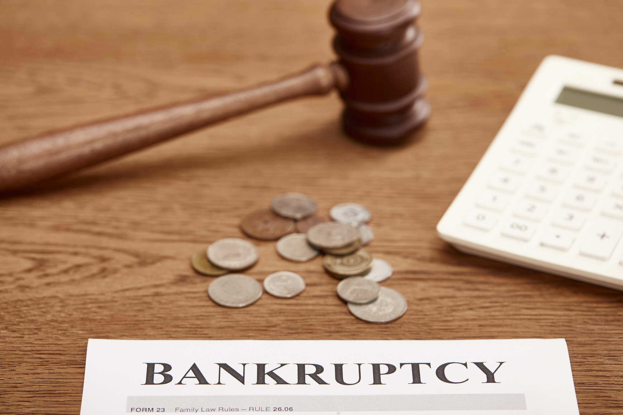 Selective-focus-of-bankruptcy-form,-gavel,-calculator-and-coins